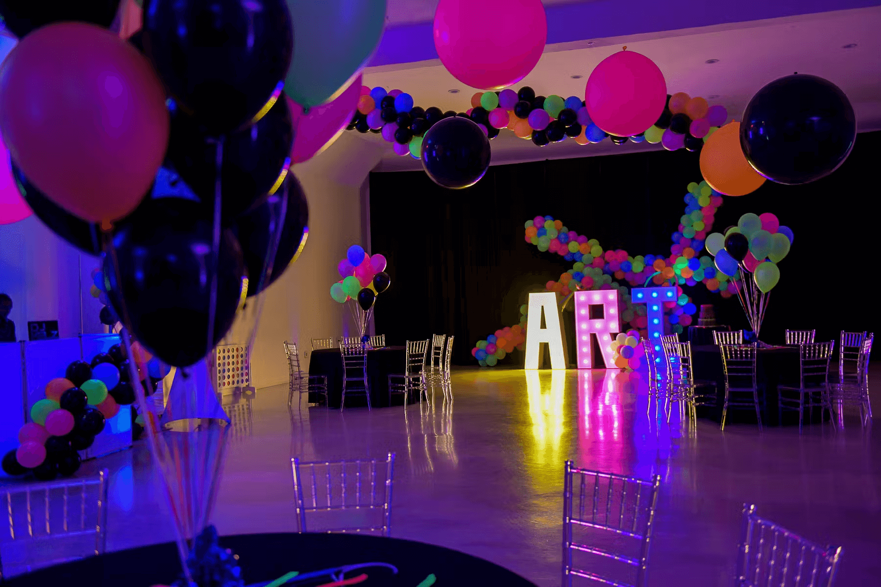 Kids celebrating in neon themed birthday party room with AR interactive walls at Singapore mall